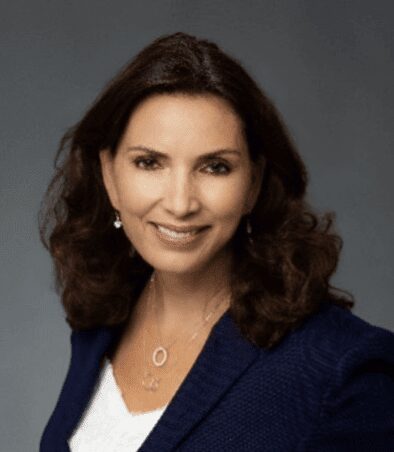 Smiling professional headshot in navy blazer